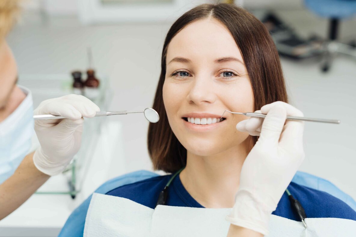 Patient smiling during a routine dental examination.