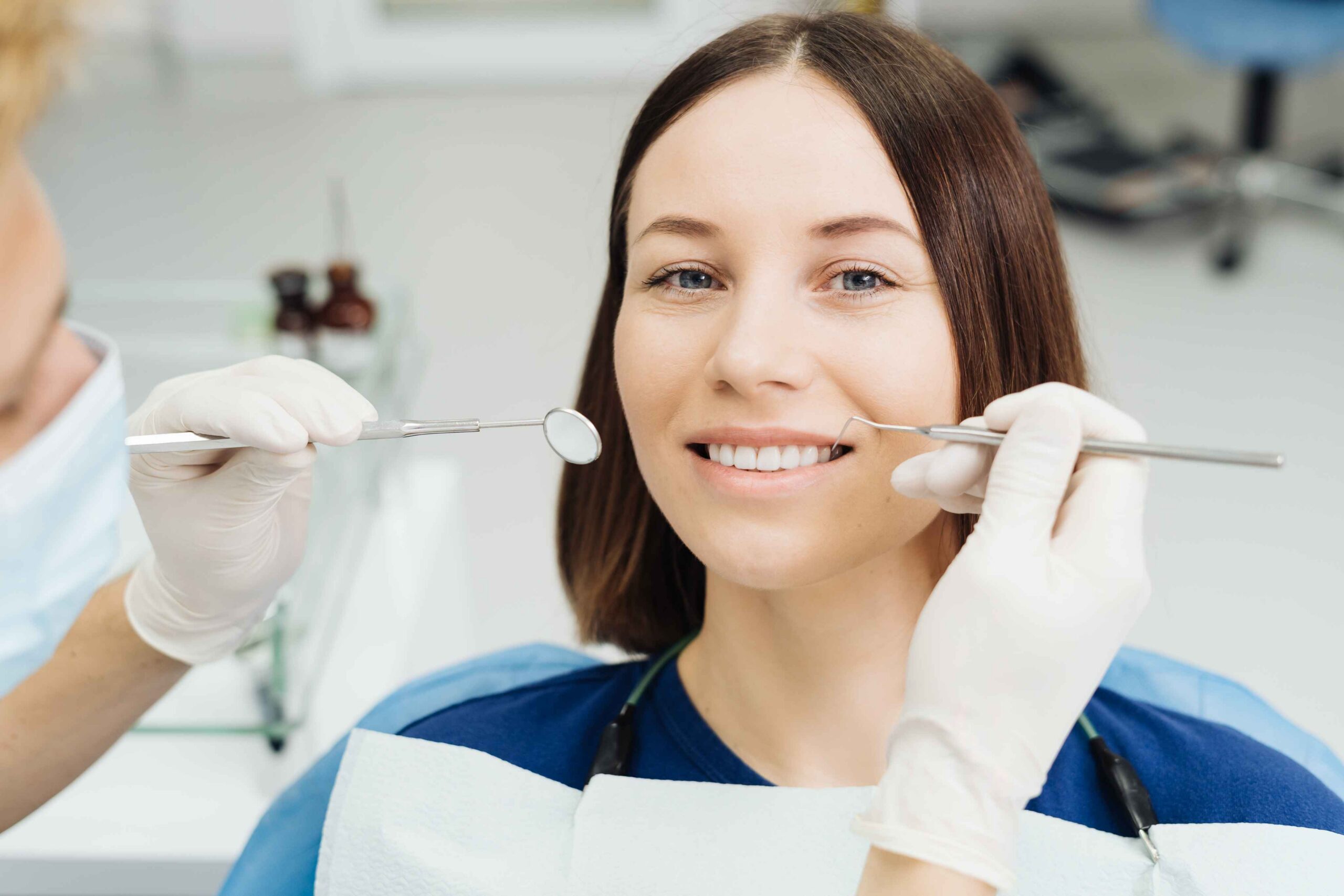 Patient smiling during a routine dental examination.