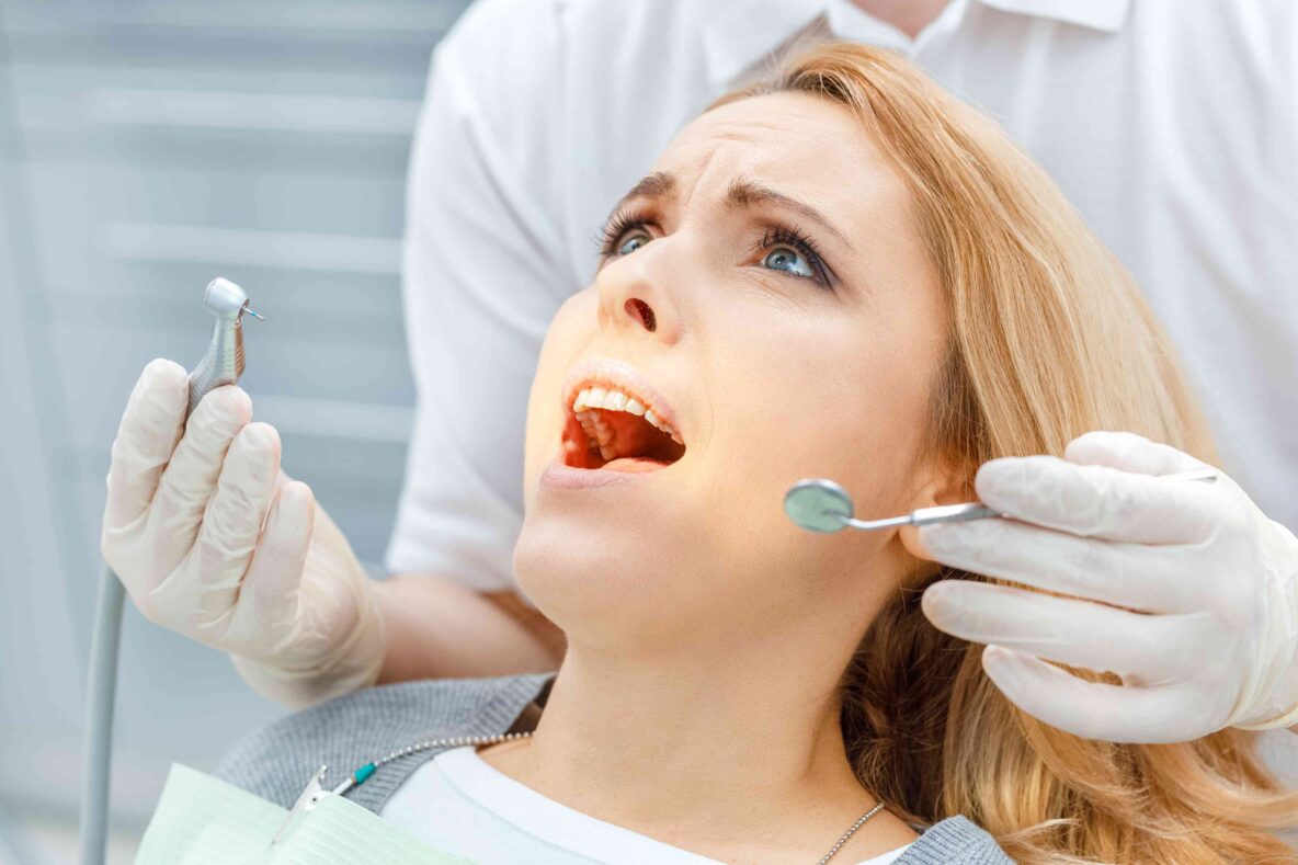 Dentist examining patient’s teeth